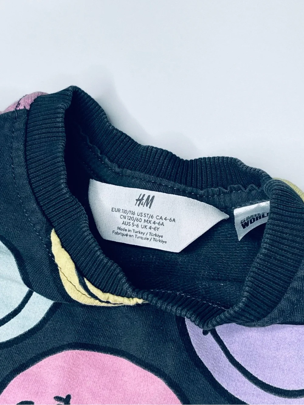 H&M Black Sweatshirt with Pastel Multicolor Smiley Faces